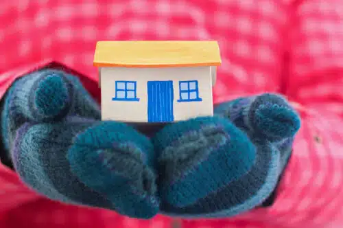 girl holding house wearing gloves - winter homeschooling